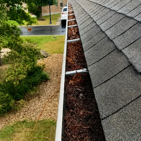 Gutter before cleaning — debris visible