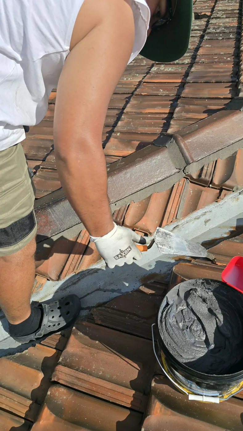Applying flexible pointing along a terracotta ridge line by hand