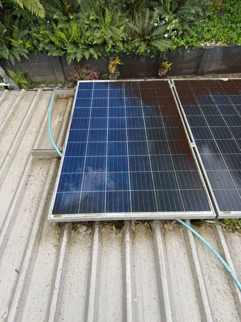 Solar panel with a cleaned test area next to a dark, grimy section on the same panel