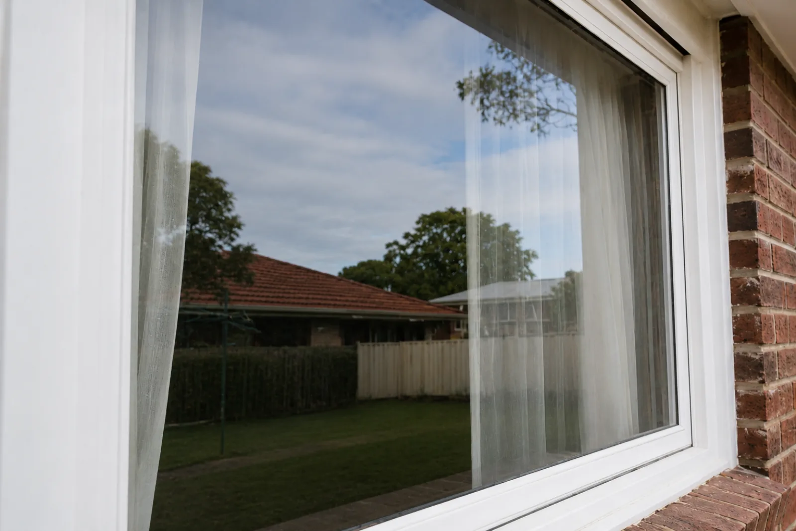 Clean exterior residential window with crystal clear glass after professional cleaning